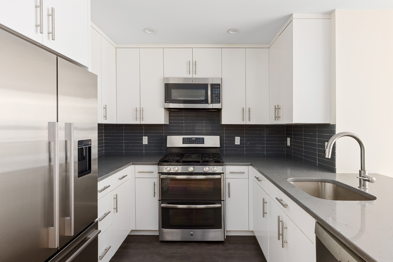 74 Adelphi Street, Unit 2B Brooklyn, NY 11205 - Photo 2 of 9 a kitchen with stainless steel appliances granite countertop a stove a sink and a refrigerator