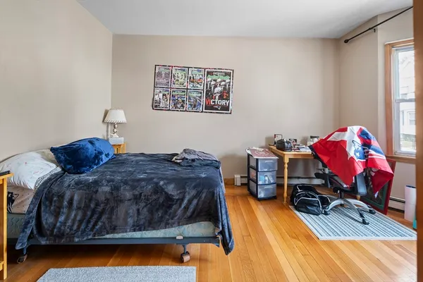 a bed sitting in a bedroom next to a window