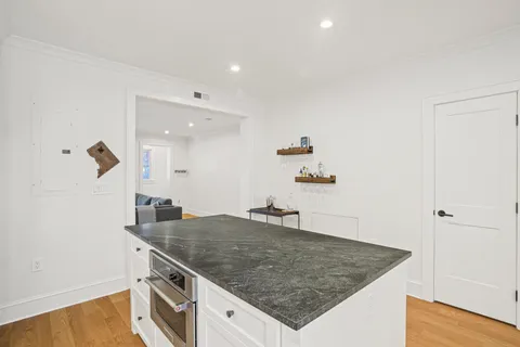 a kitchen with kitchen island a sink a stove and a refrigerator