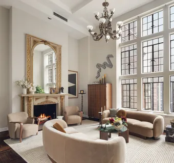 a living room with furniture a fireplace and a chandelier