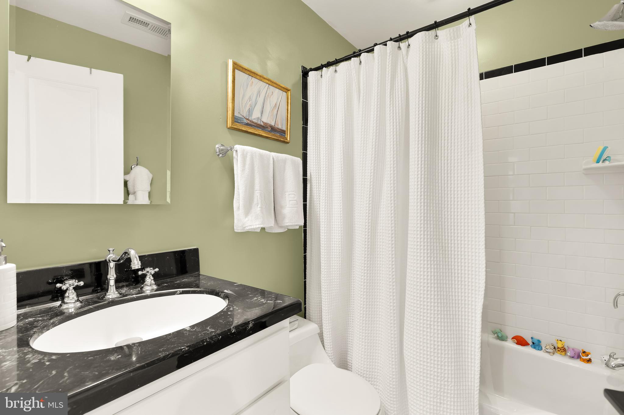 1354 Kenyon Street Northwest, Unit G Washington, DC 20010 - Photo 26 of 37 a bathroom with a sink vanity mirror and a toilet