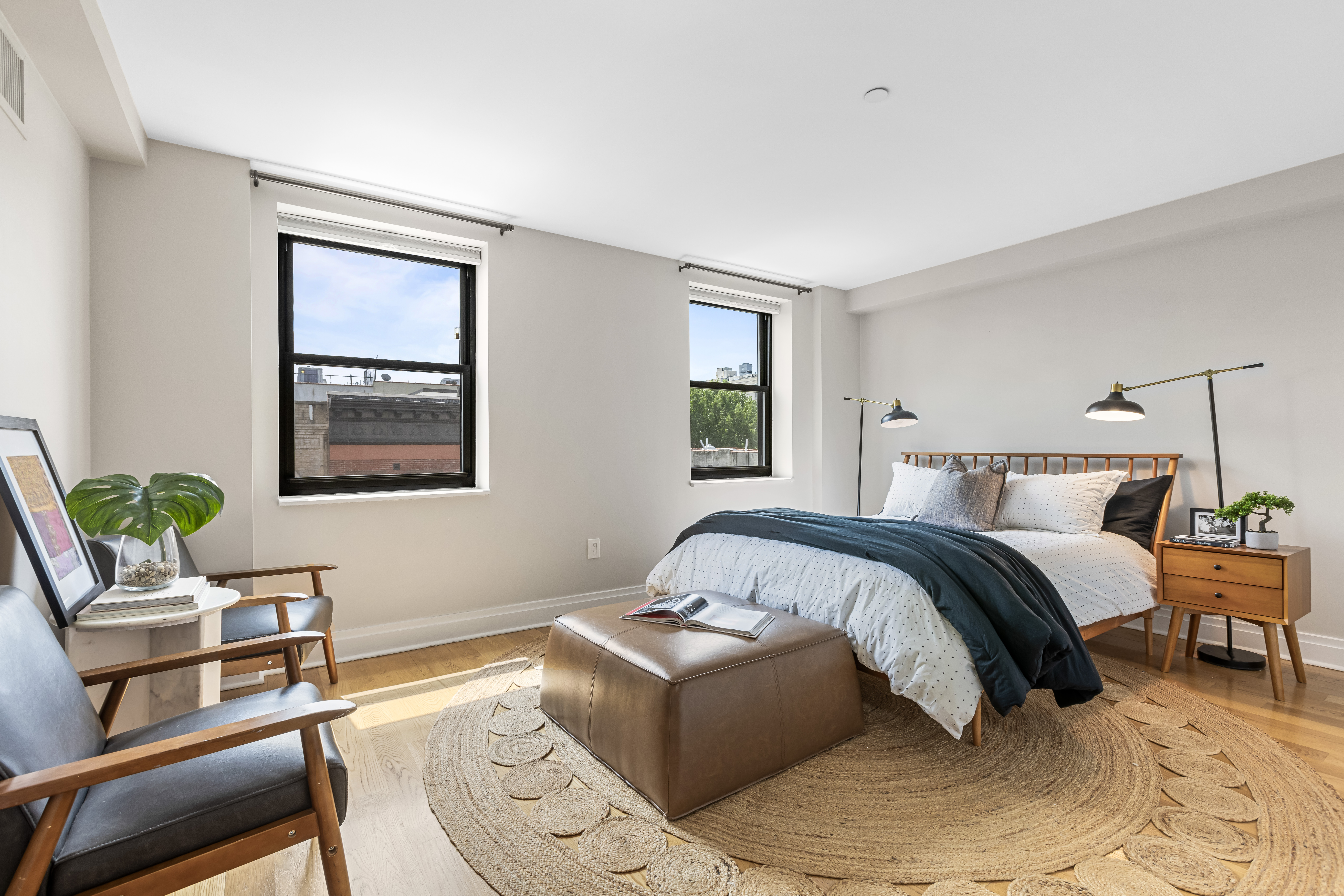 257 West 117th Street, Unit 6A Manhattan, NY 10026 - Photo 10 of 16 a bedroom with a bed and wooden floor