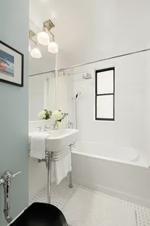 a bathroom with a sink bath tub and a mirror