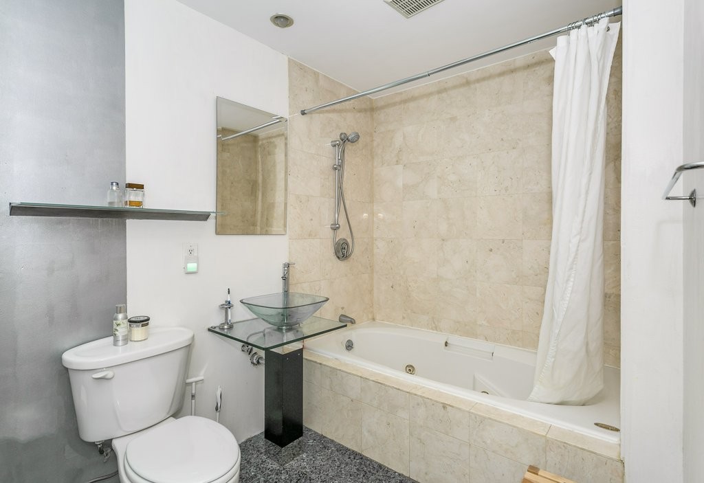 453 Washington Street, Unit 5D Boston, MA 02111 - Photo 17 of 17 a bathroom with a sink toilet and shower