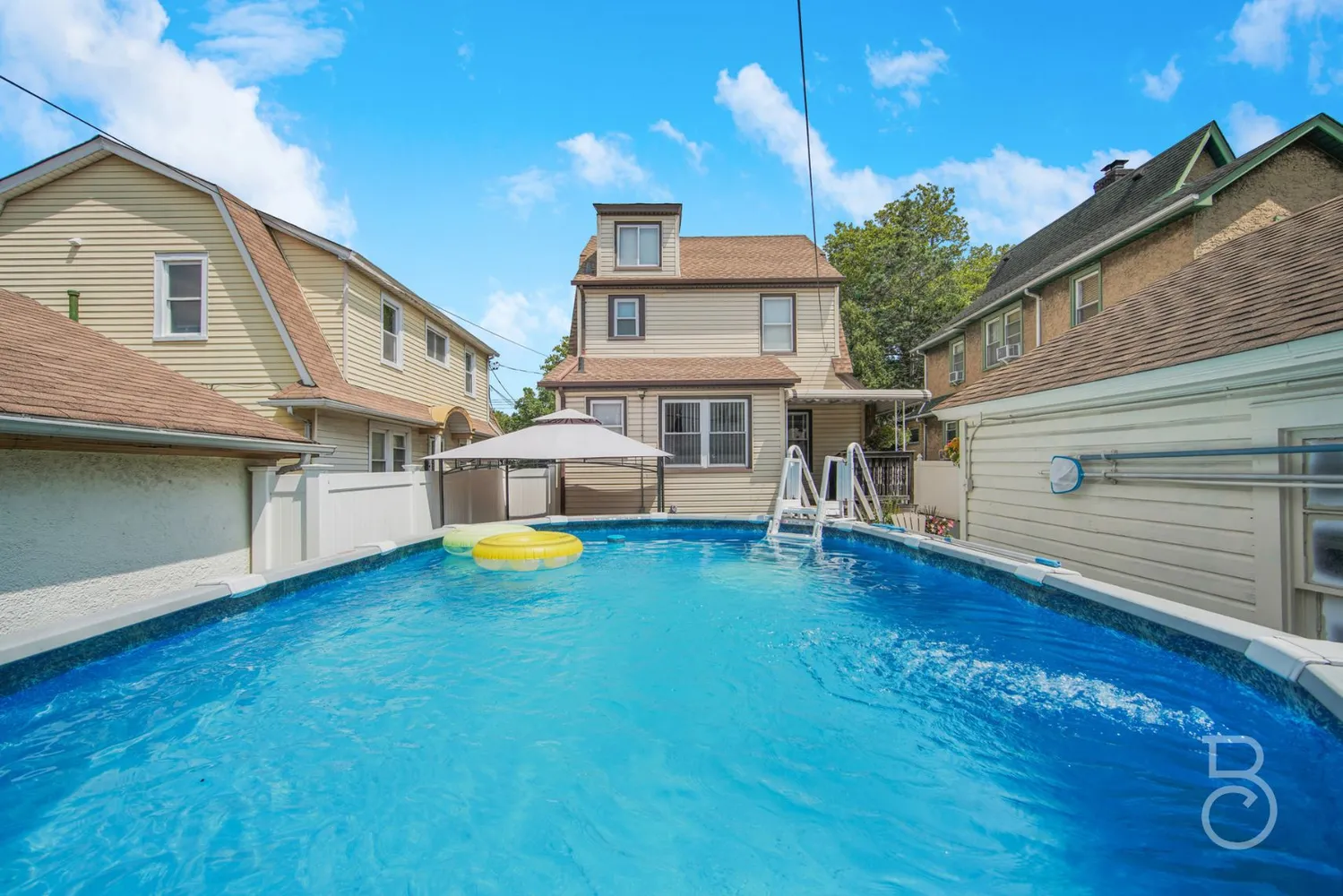 a front view of a house with yard and balcony