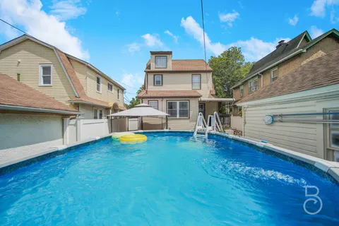 a front view of a house with yard and balcony
