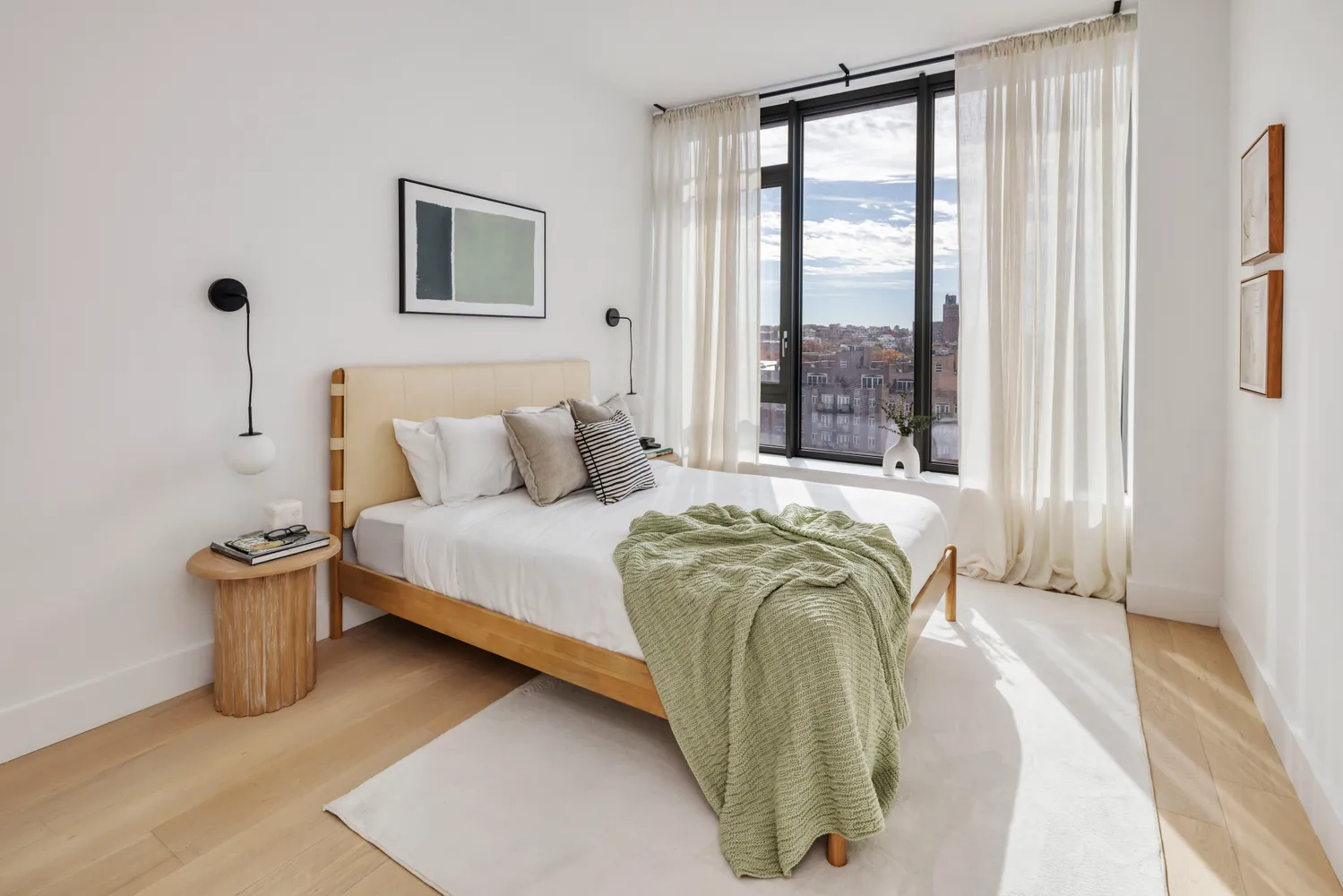 a bedroom with a bed and a large window