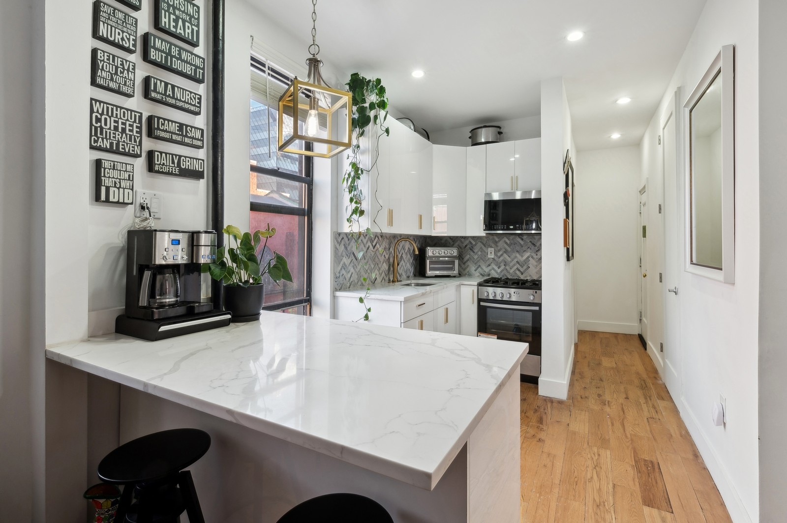 66 West 138th Street, Unit 3A Manhattan, NY 10037 - Photo 2 of 8 a kitchen with kitchen island a sink appliances and cabinets