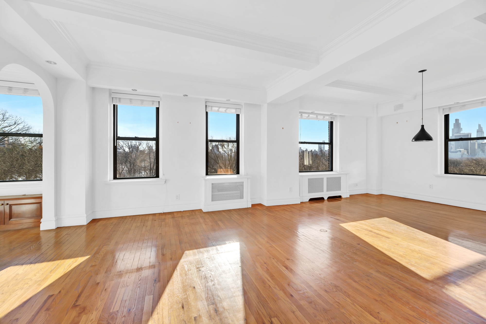 225 Central Park West, Unit 801 Manhattan, NY 10024 - Photo 2 of 21 a view of an empty room with window and wooden floor