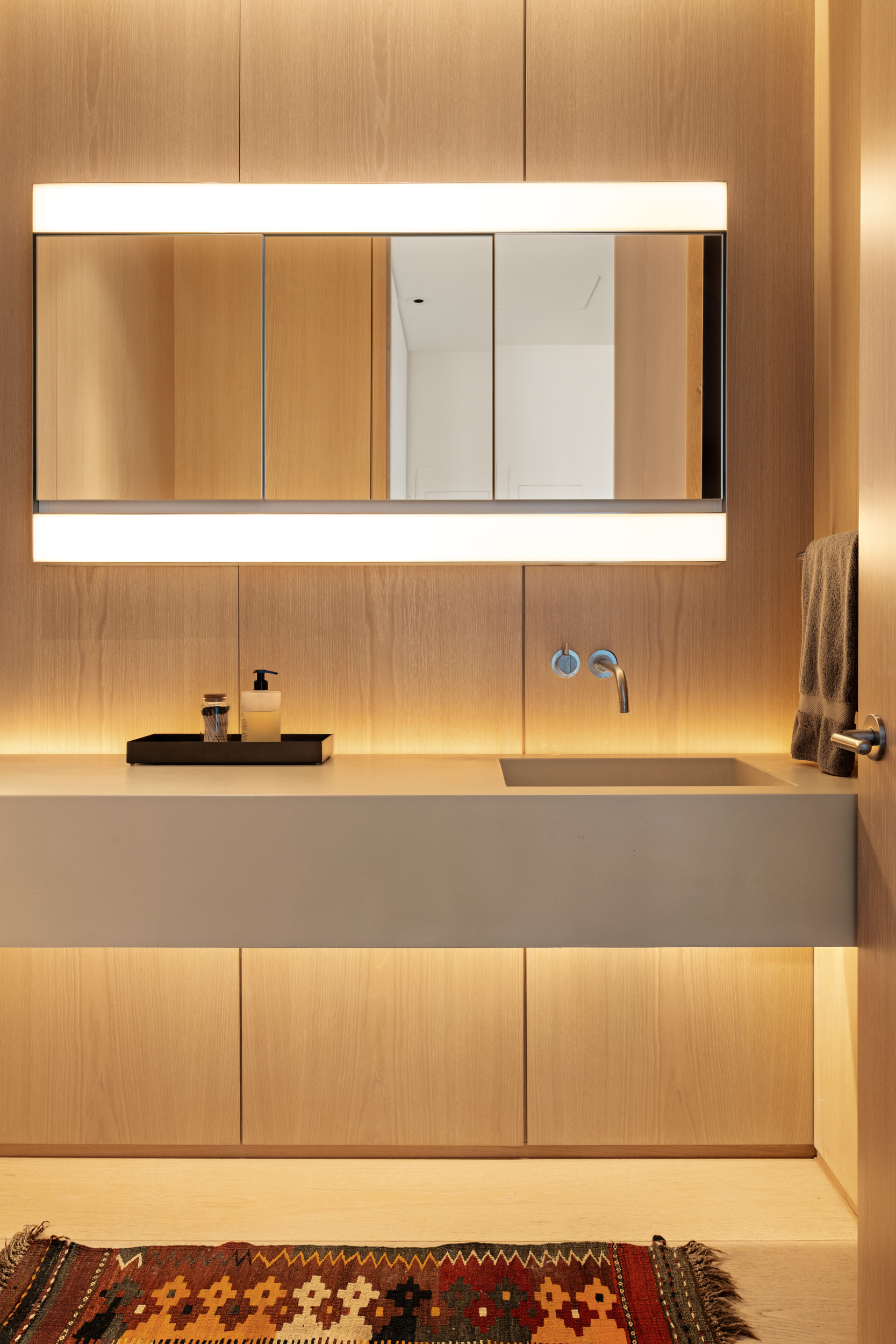 215 Chrystie Street, Unit 29W Manhattan, NY 10002 - Photo 20 of 24 a bathroom with a sink and a mirror