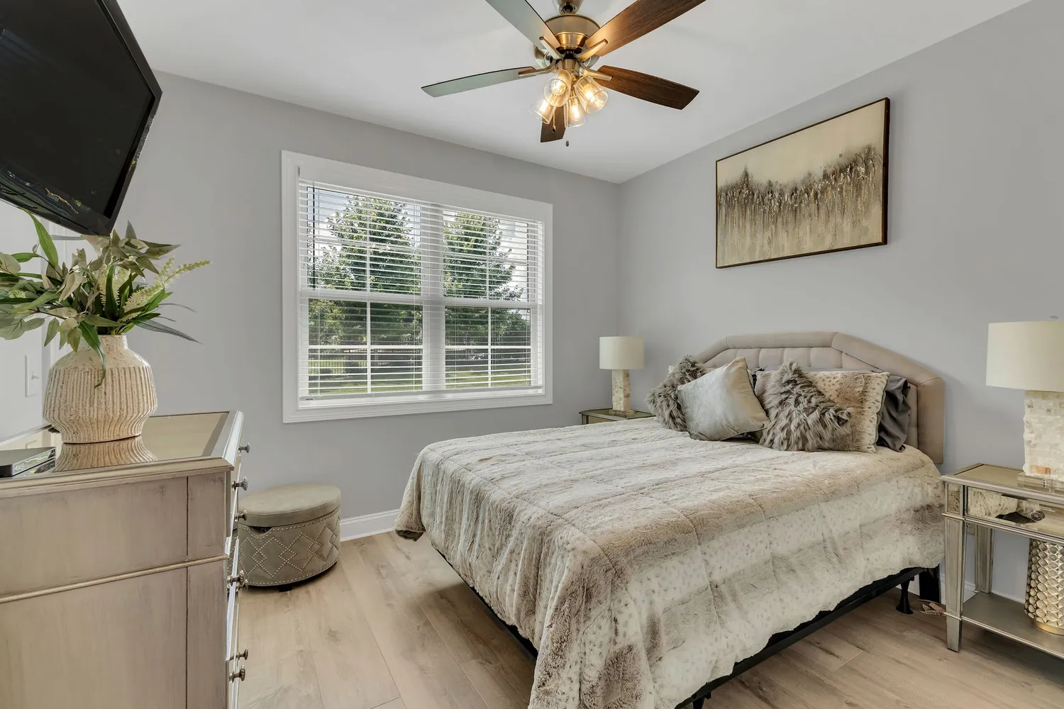 a bedroom with a bed and a potted plant
