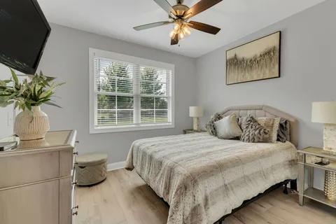 a bedroom with a bed and a potted plant