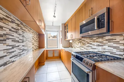 a kitchen with stainless steel appliances granite countertop a stove and a sink