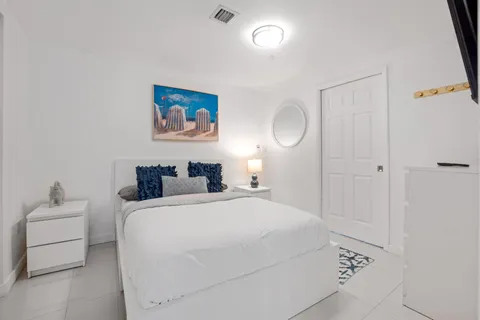 a bedroom with a bed and a lamp