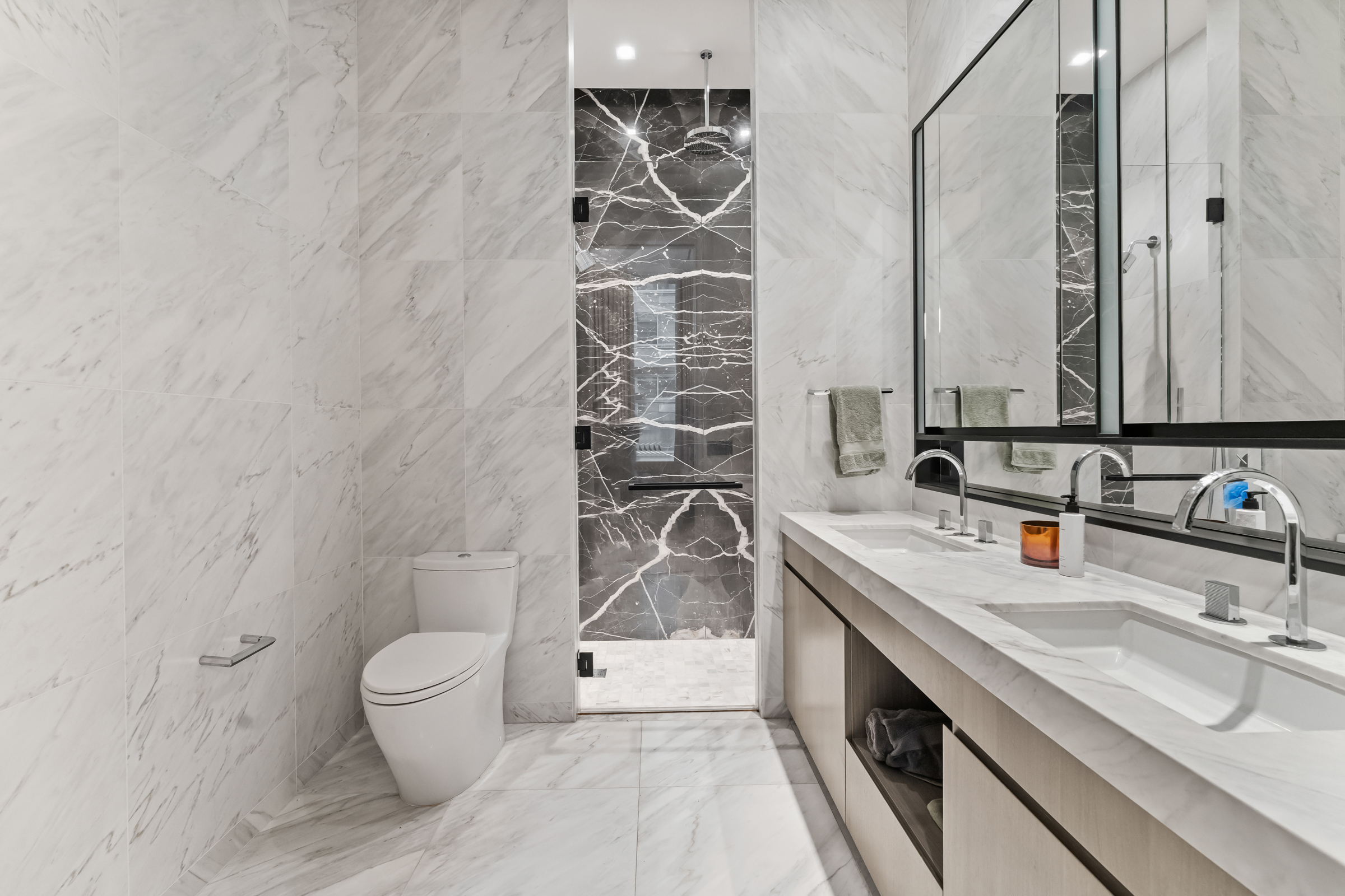 108 Leonard Street, Unit 4K Manhattan, NY 10013 - Photo 8 of 11 a bathroom with a double vanity sink a toilet and a mirror