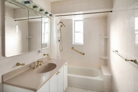 a bathroom with a sink mirror toilet and bathtub