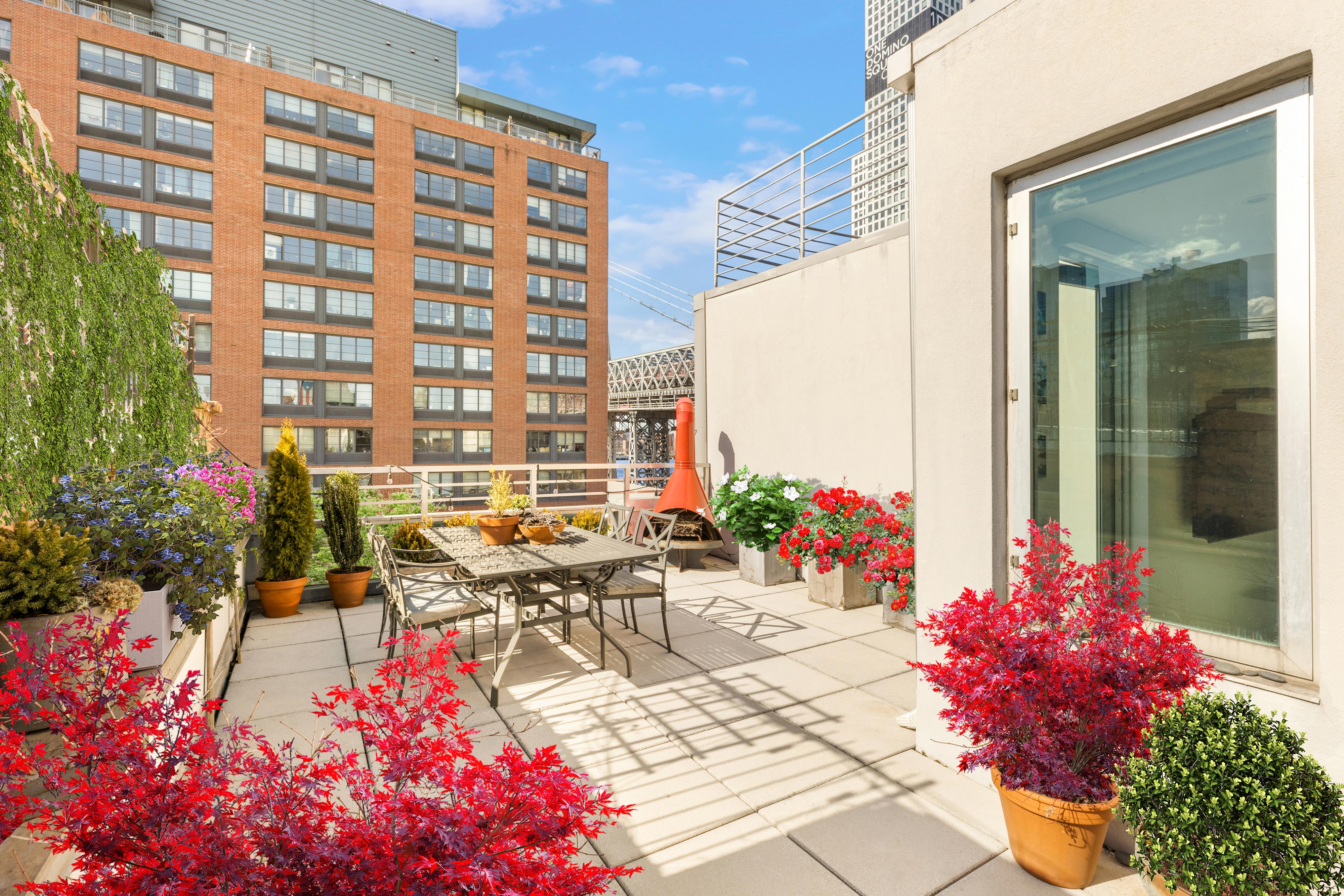 24 Dunham Place, Unit PHA Brooklyn, NY 11249 - Photo 15 of 19 a view of a patio with table and chairs and potted plants