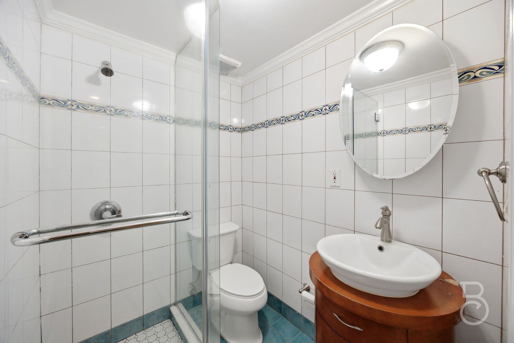22-61 46th Street Queens, NY 11105 - Photo 13 of 24 a bathroom with a sink a toilet and shower