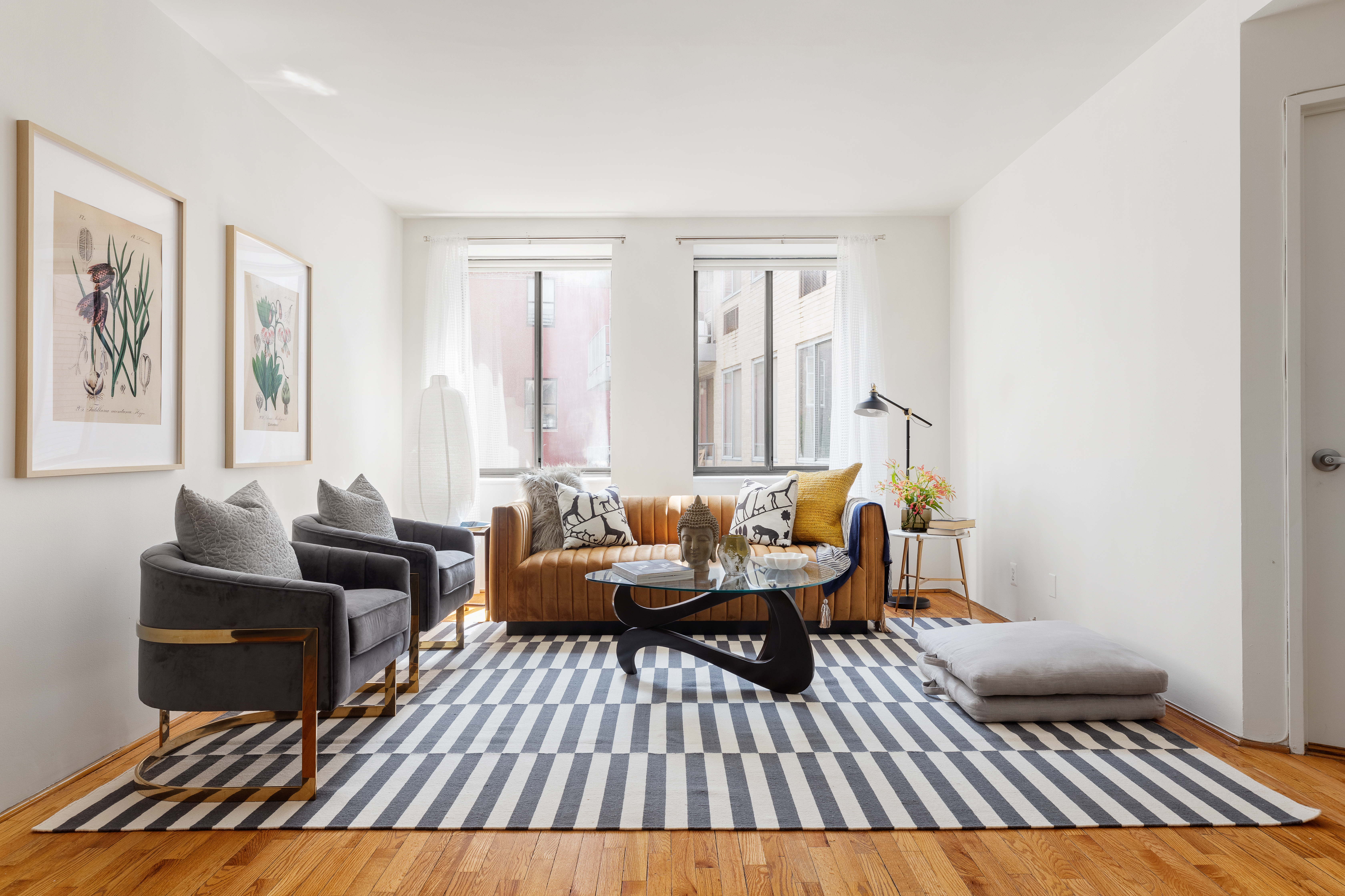 167 Perry Street, Unit 4K Manhattan, NY 10014 - Photo 2 of 11 a living room with furniture and a rug