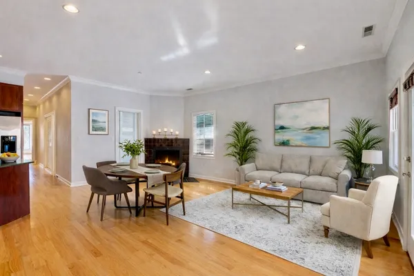 a living room with furniture a wooden floor and a fireplace