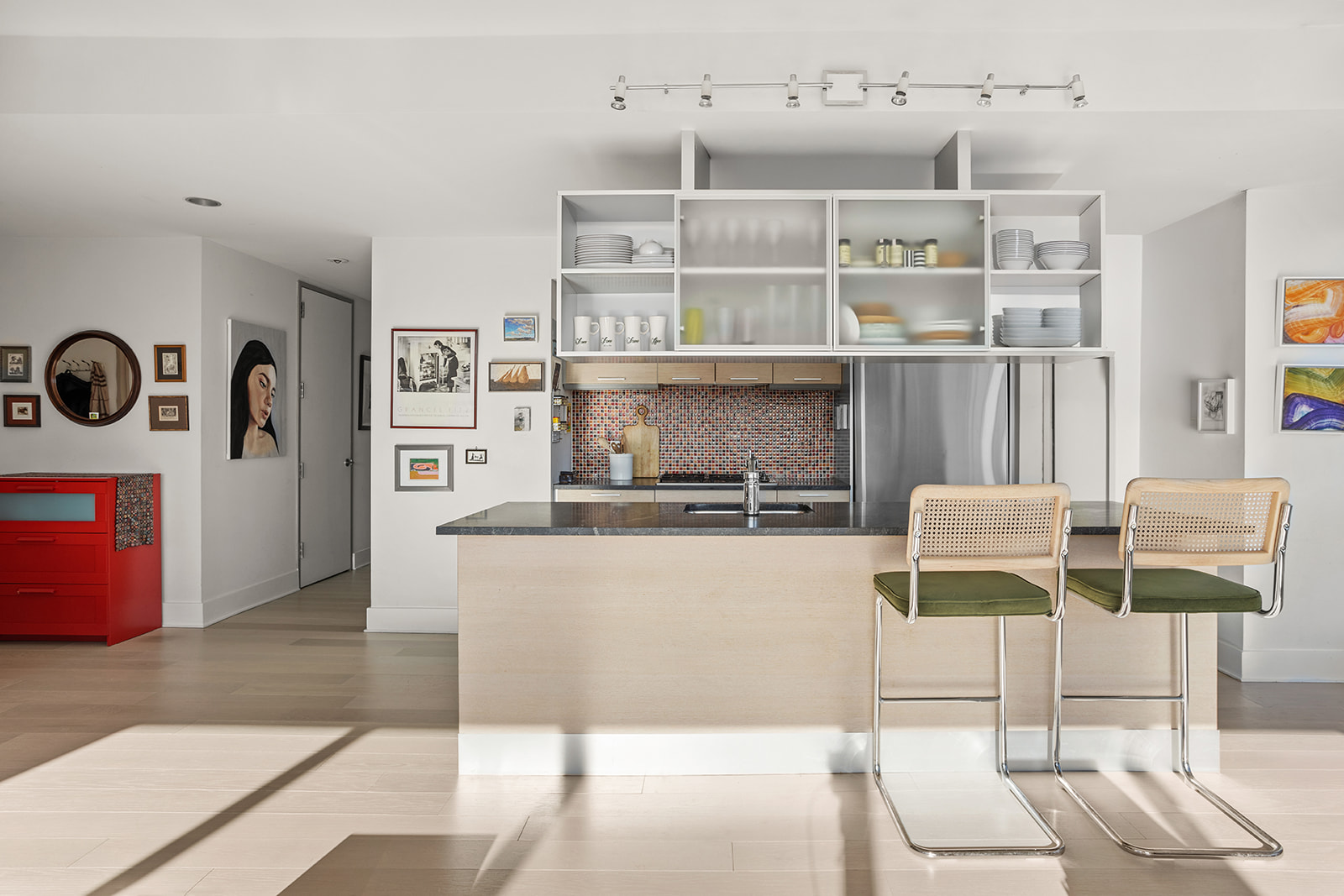 350 West 42nd Street, Unit 33G Manhattan, NY 10036 - Photo 6 of 20 a living room with stainless steel appliances furniture a rug and a kitchen view