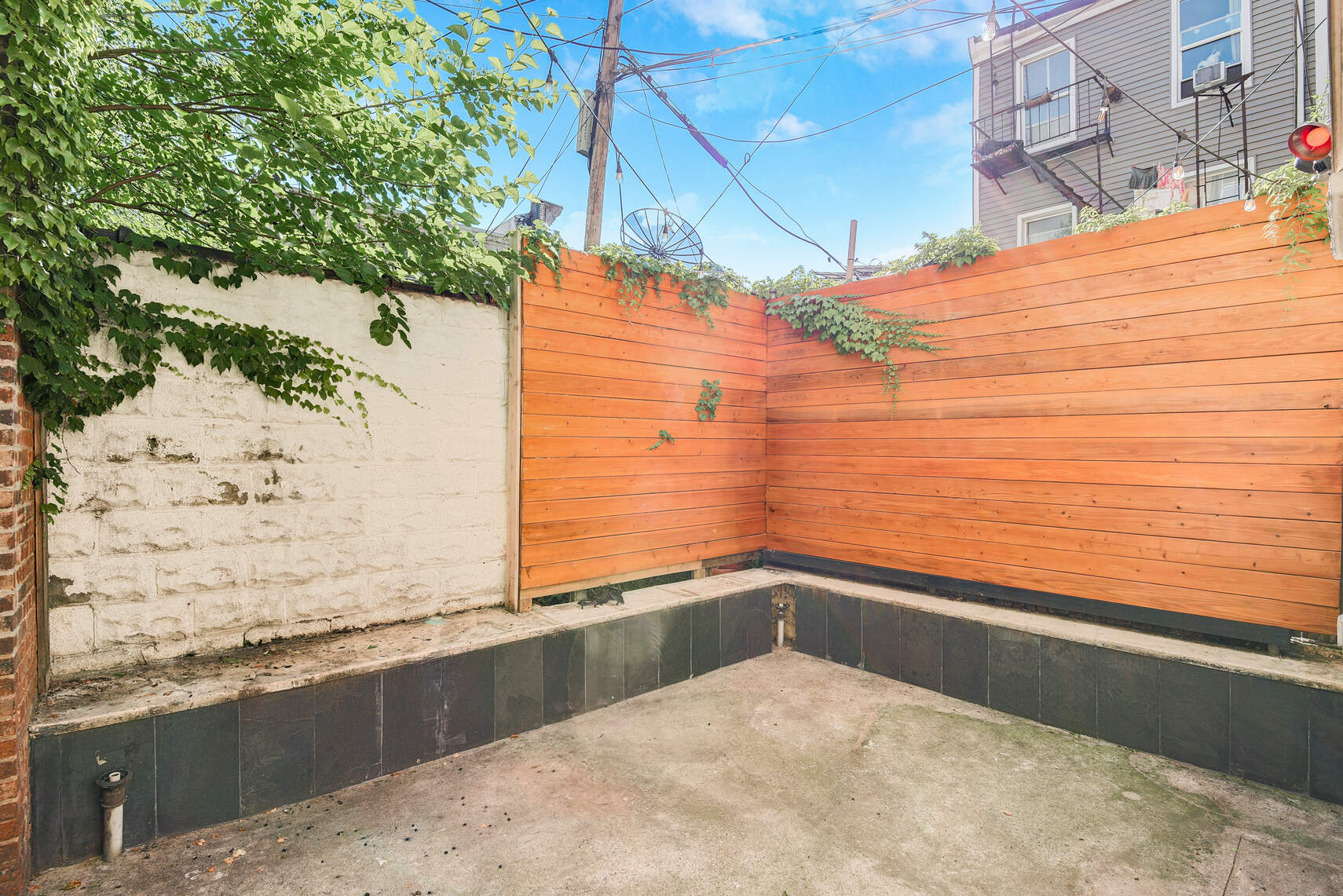 514 Hart Street, Unit PARLOR Brooklyn, NY 11221 - Photo 4 of 9 a view of terrace with wooden floor and fence