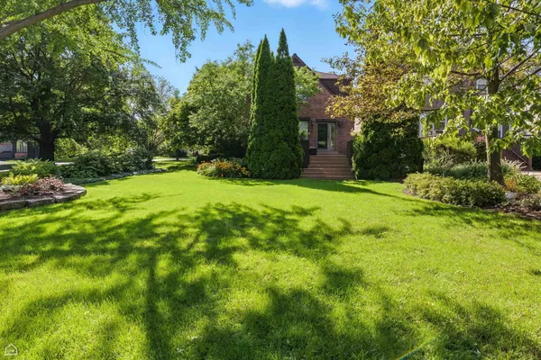 a tall yellow building in middle of the green field