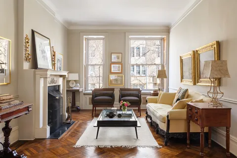 a bedroom with furniture and a fireplace