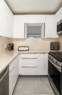 a kitchen with a sink and a stove top oven