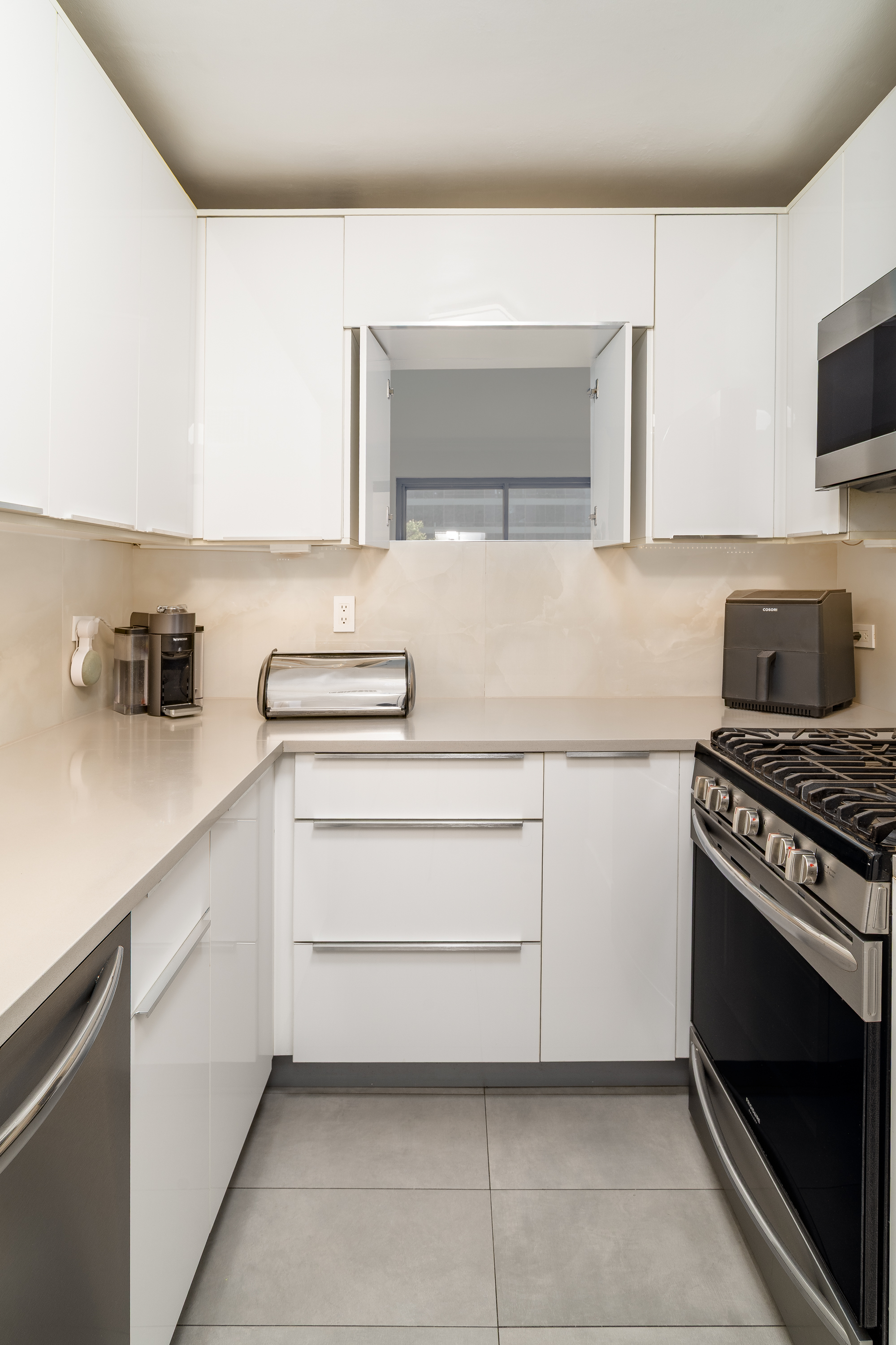 530 East 72nd Street, Unit 7C Manhattan, NY 10021 - Photo 10 of 17 a kitchen with a sink and a stove top oven
