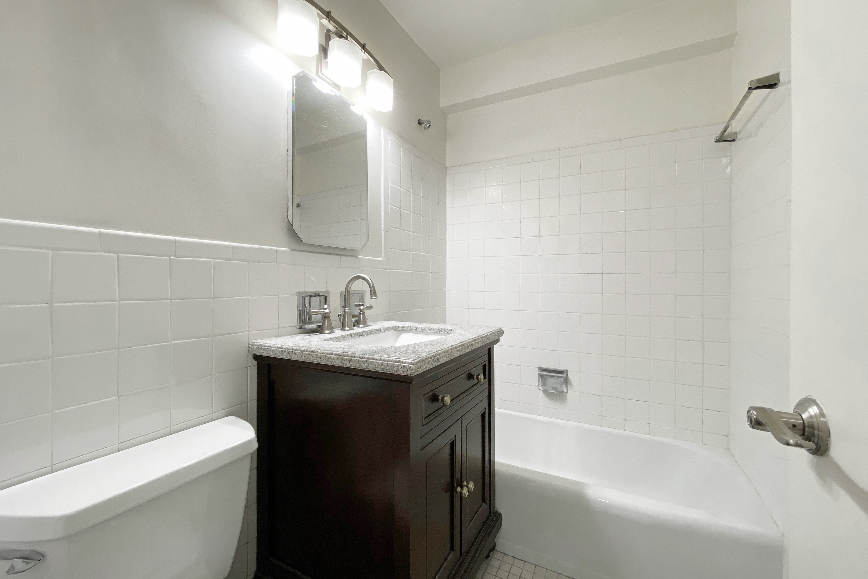 343 East 30th Street, Unit 16D Manhattan, NY 10016 - Photo 7 of 17 a bathroom with a granite countertop sink toilet and shower