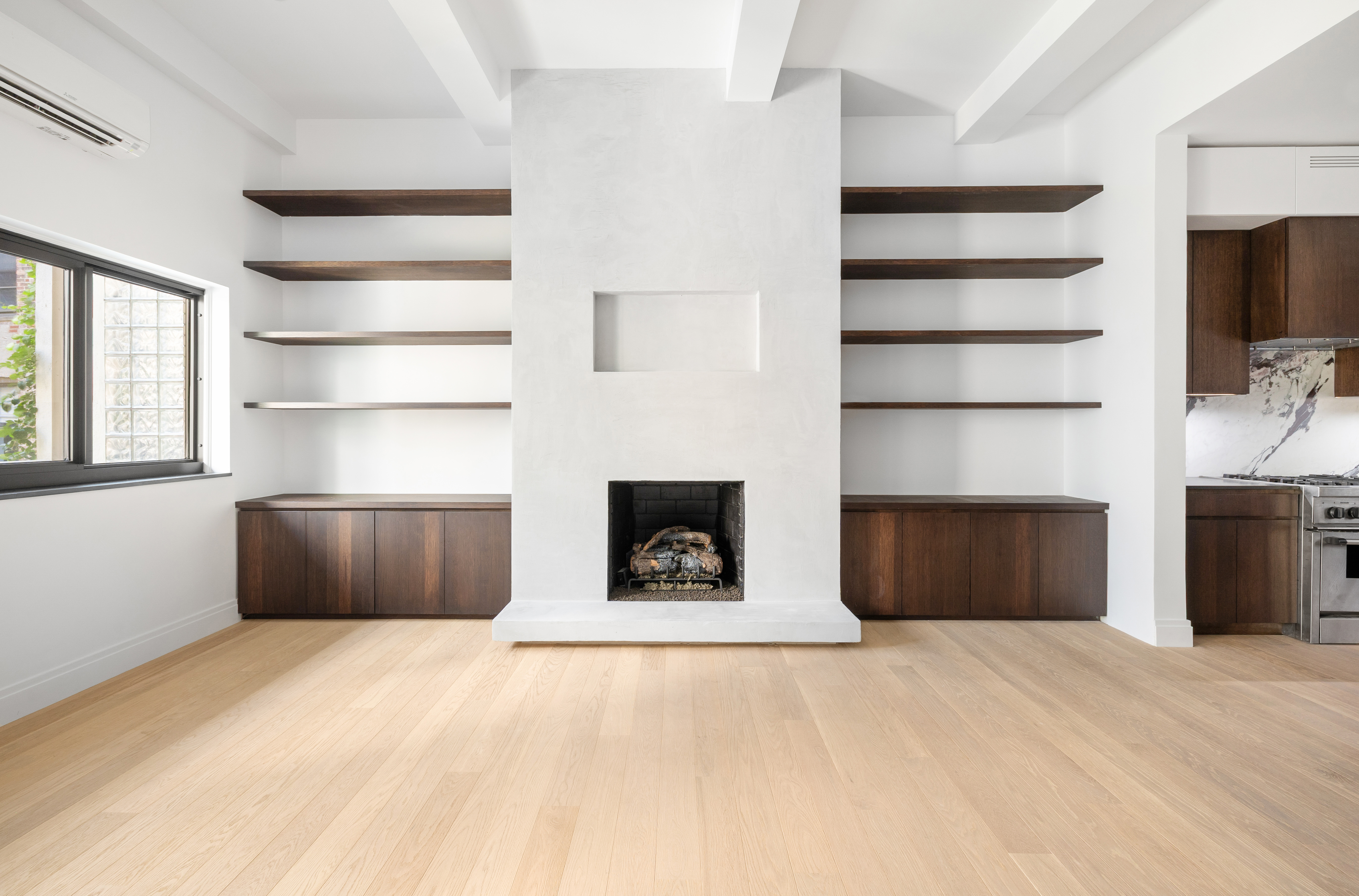 69 Bank Street, Unit 203 Manhattan, NY 10014 - Photo 9 of 23 a view of an empty room with a fireplace and a window