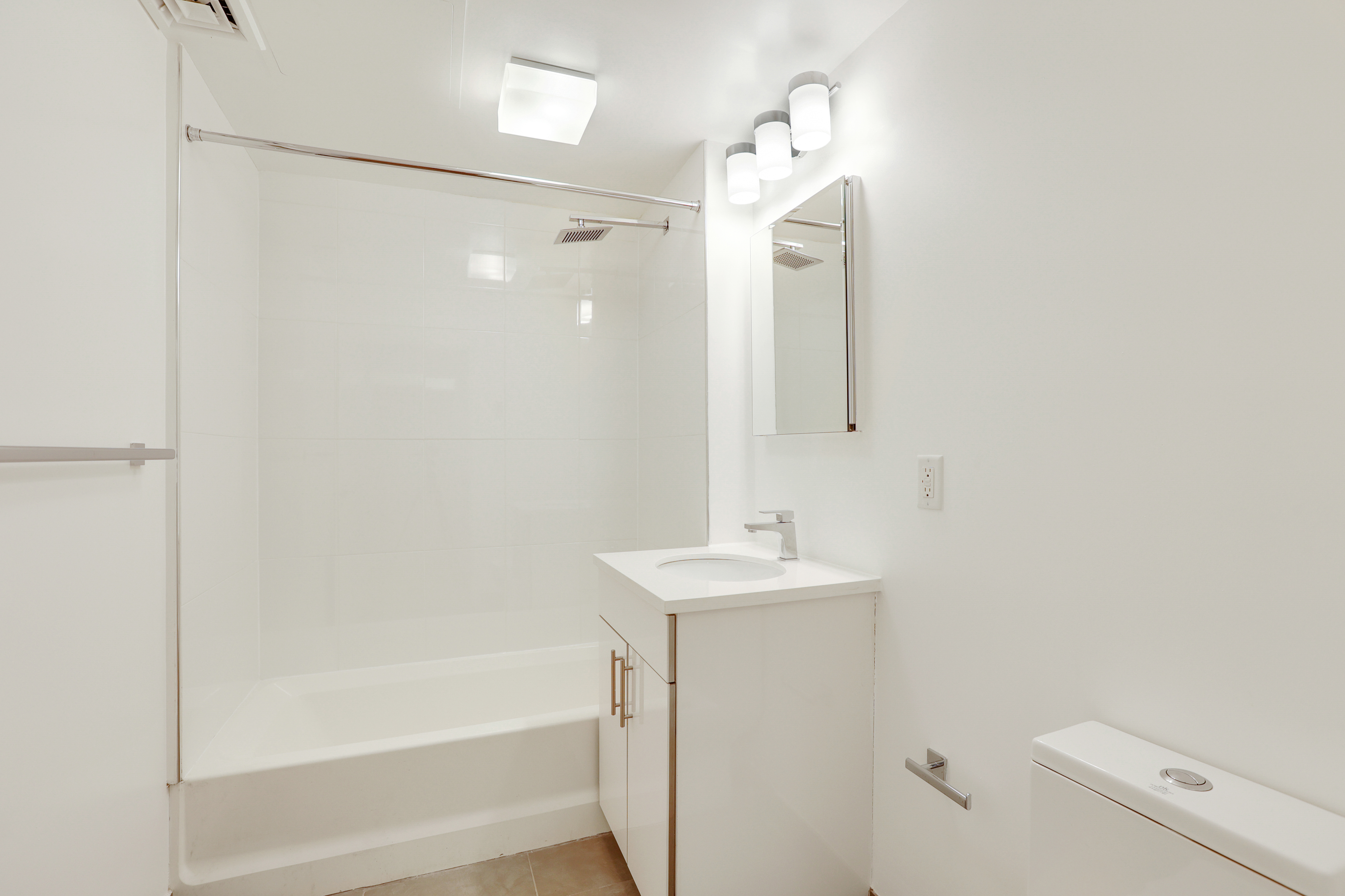 230 West 75th Street, Unit 4 Manhattan, NY 10023 - Photo 10 of 16 a bathroom with a shower a sink and a toilet