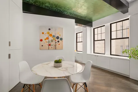 a view of a dining room with furniture and window