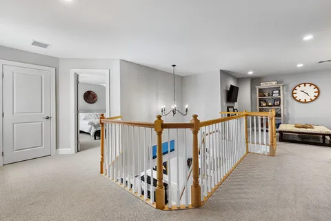 a view of a livingroom with furniture and staircase