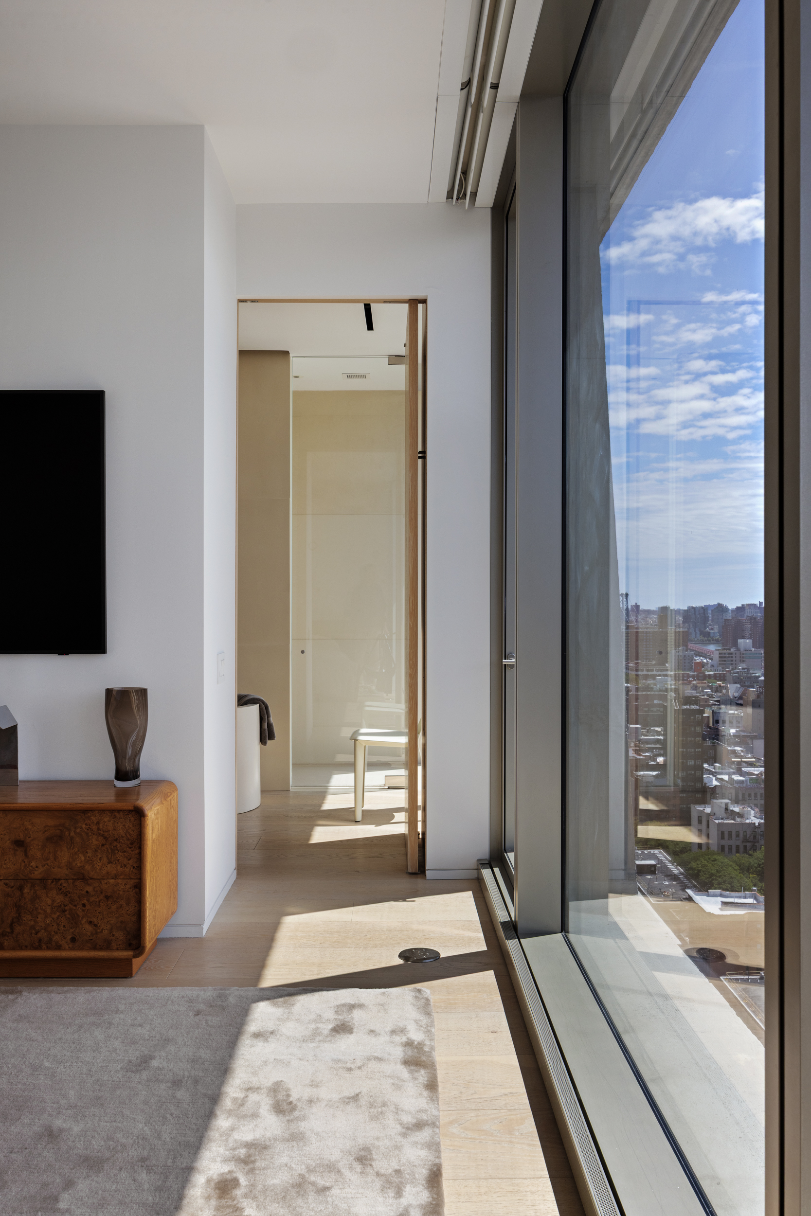 215 Chrystie Street, Unit 29W Manhattan, NY 10002 - Photo 18 of 24 a living room with a couch and a flat screen tv