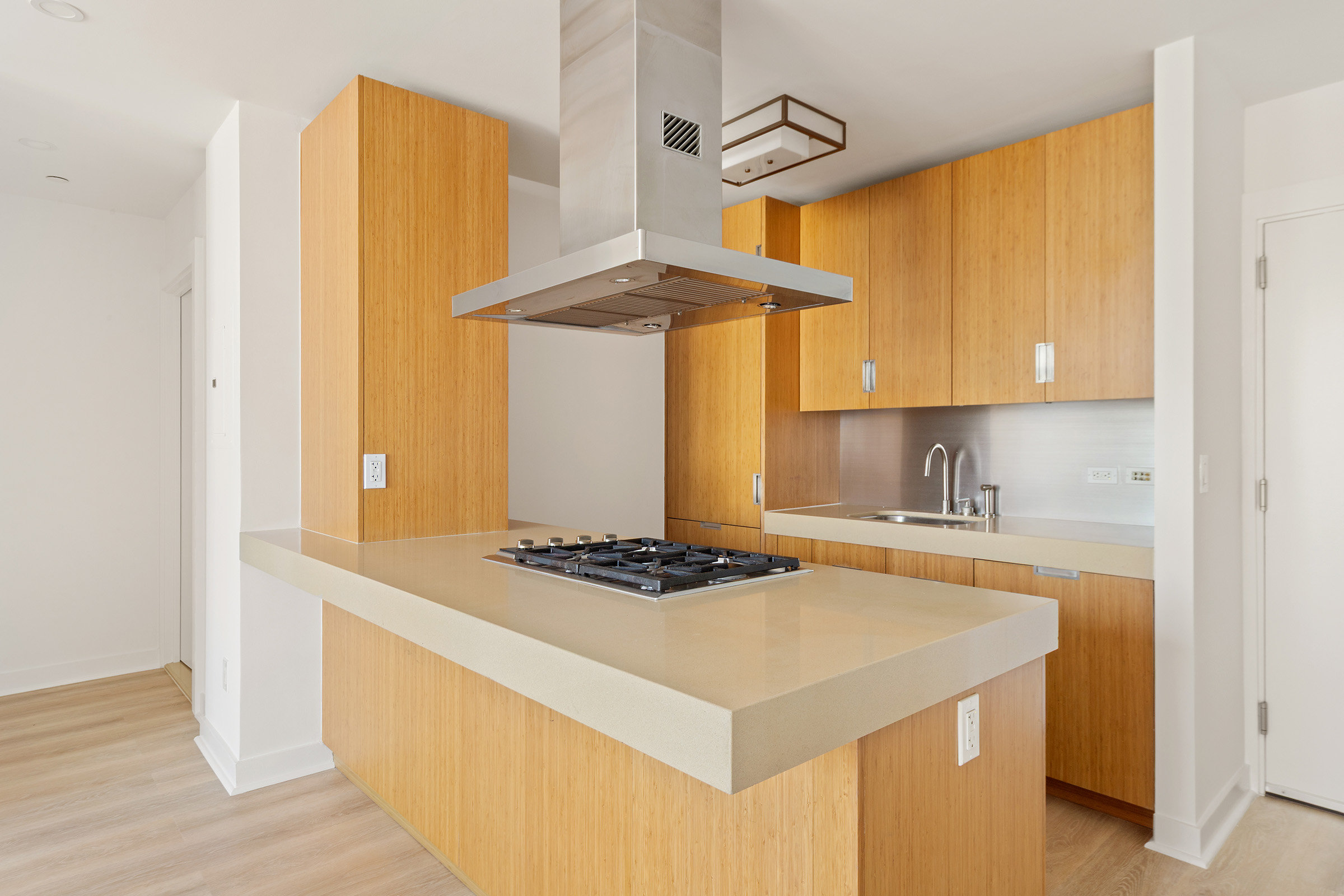 450 West 17th Street, Unit 1123 Manhattan, NY 10011 - Photo 4 of 6 a kitchen with stainless steel appliances a stove a sink and a refrigerator