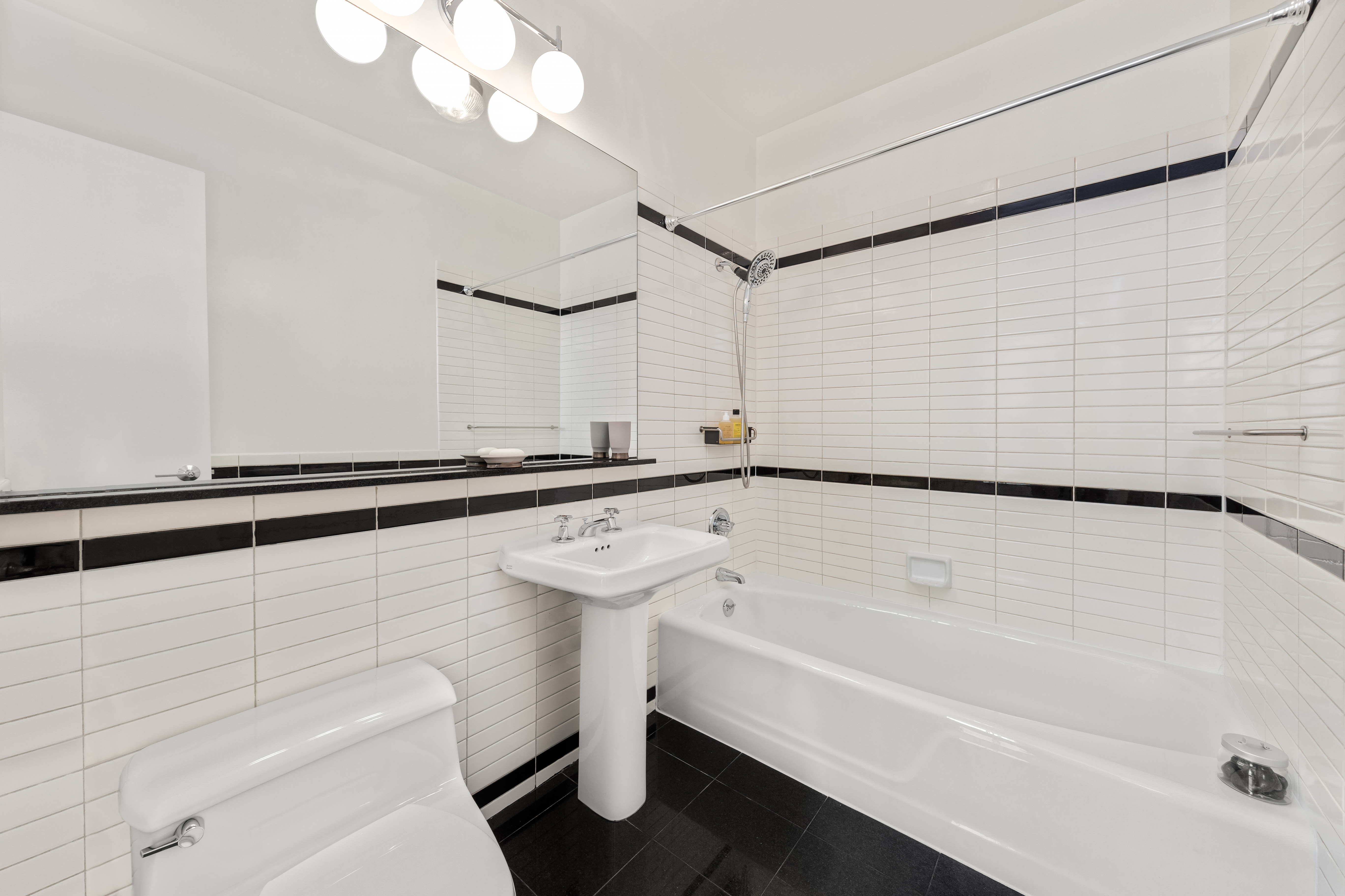 360 East 88th Street, Unit 31C Manhattan, NY 10128 - Photo 15 of 24 a bathroom with a sink a toilet and a bathtub