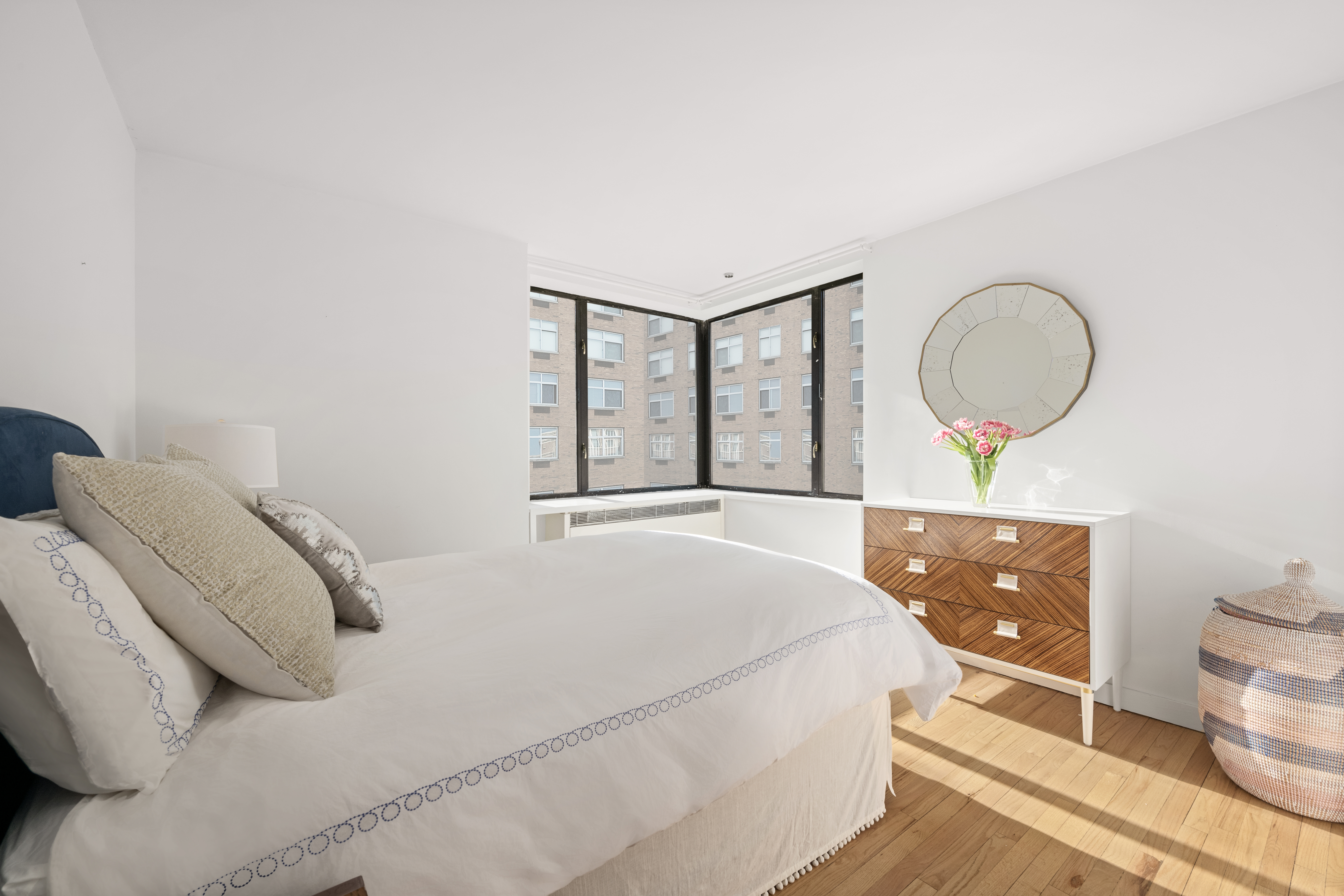 30 West 61st Street, Unit 9C Manhattan, NY 10023 - Photo 6 of 10 a bedroom with a bed and a dresser