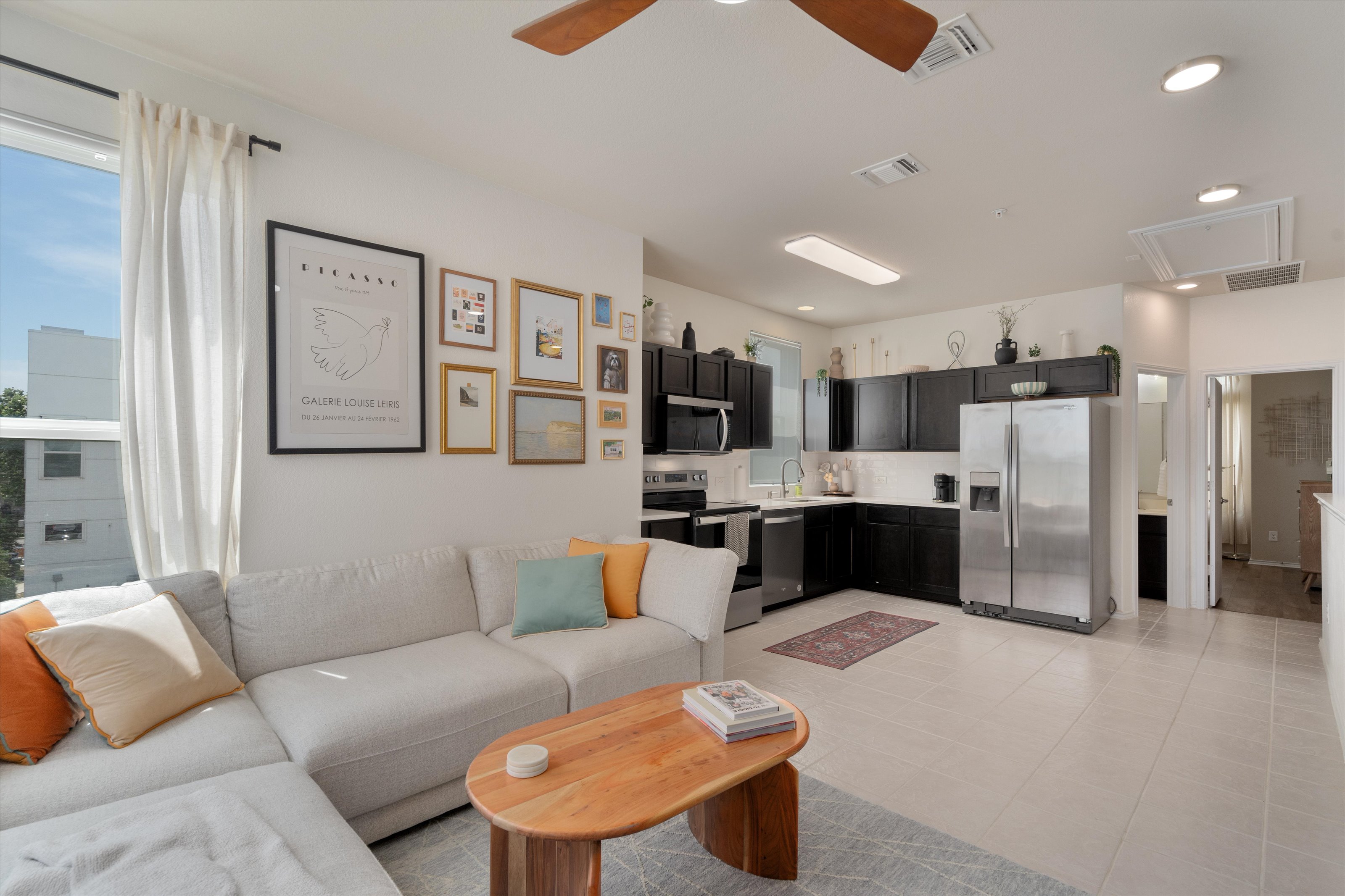 4330 Olenick Street Austin, TX 78723 - Photo 2 of 29 a living room with furniture and kitchen view