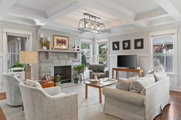 a living room with furniture a fireplace and a flat screen tv
