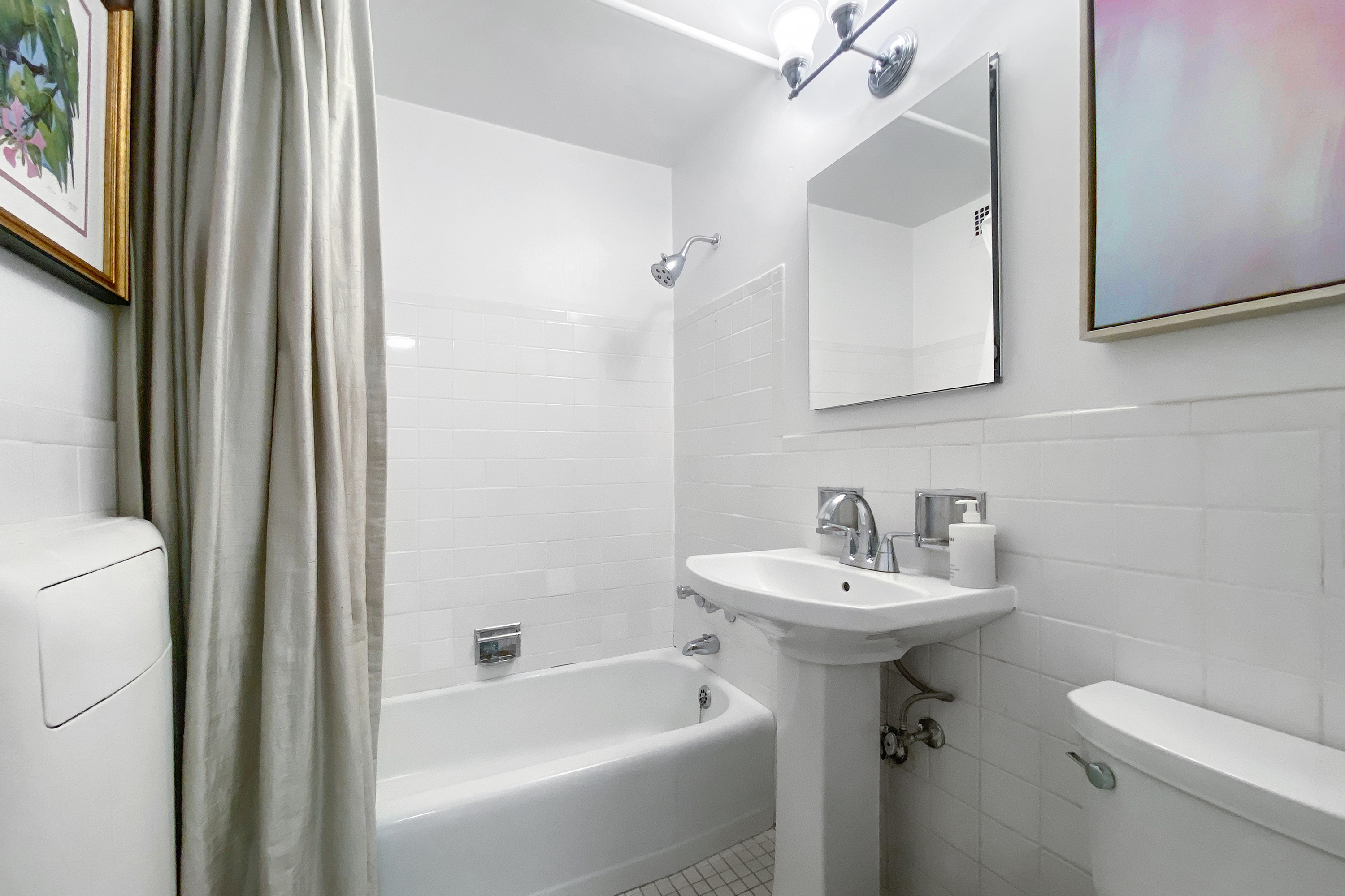 300 East 33rd Street, Unit 10A Manhattan, NY 10016 - Photo 4 of 14 a bathroom with a sink toilet and shower