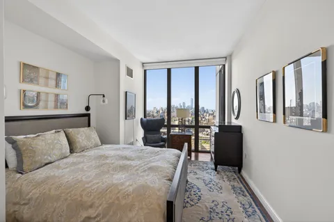 a bedroom with a large bed and a large window