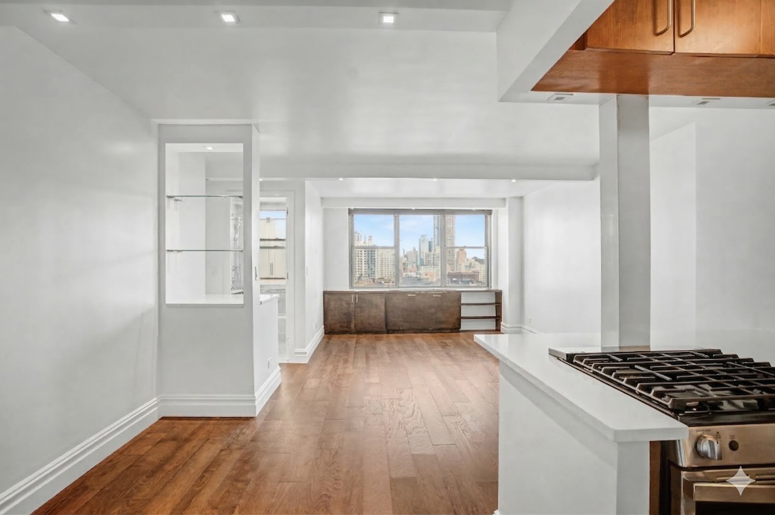 301 East 79th Street, Unit 17F Manhattan, NY 10075 - Photo 2 of 15 a view of a livingroom with wooden floor and kitchen space