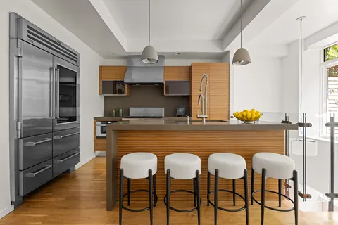 a dining table chairs window and stainless steel appliances