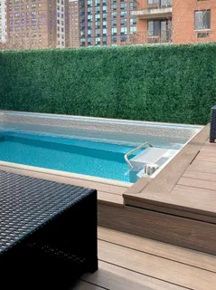 a view of a balcony with a floor to ceiling window and grass