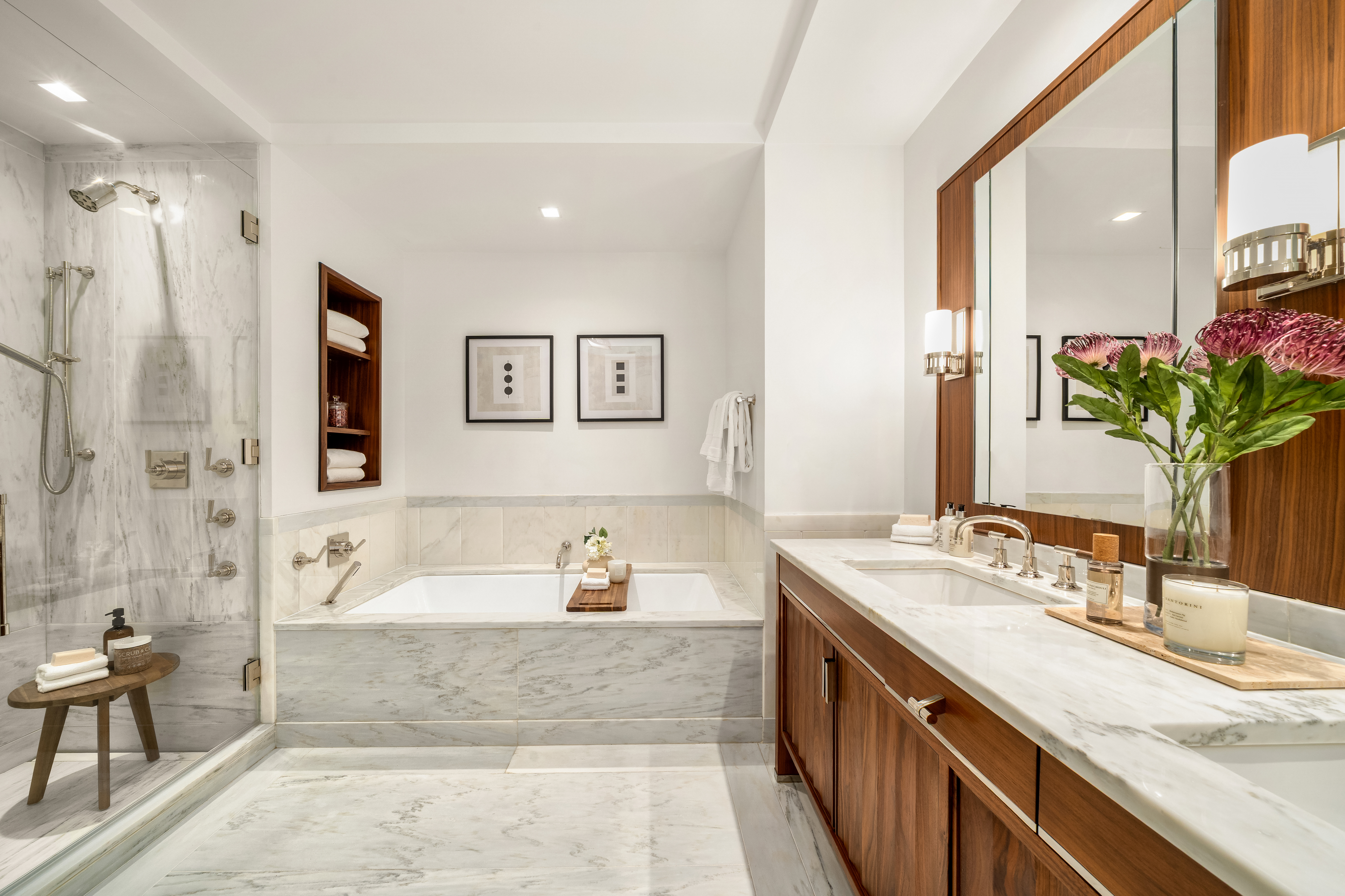 150 Charles Street, Unit 14B Manhattan, NY 10014 - Photo 9 of 20 a spacious bathroom with a double vanity sink a large mirror a bathtub and shower
