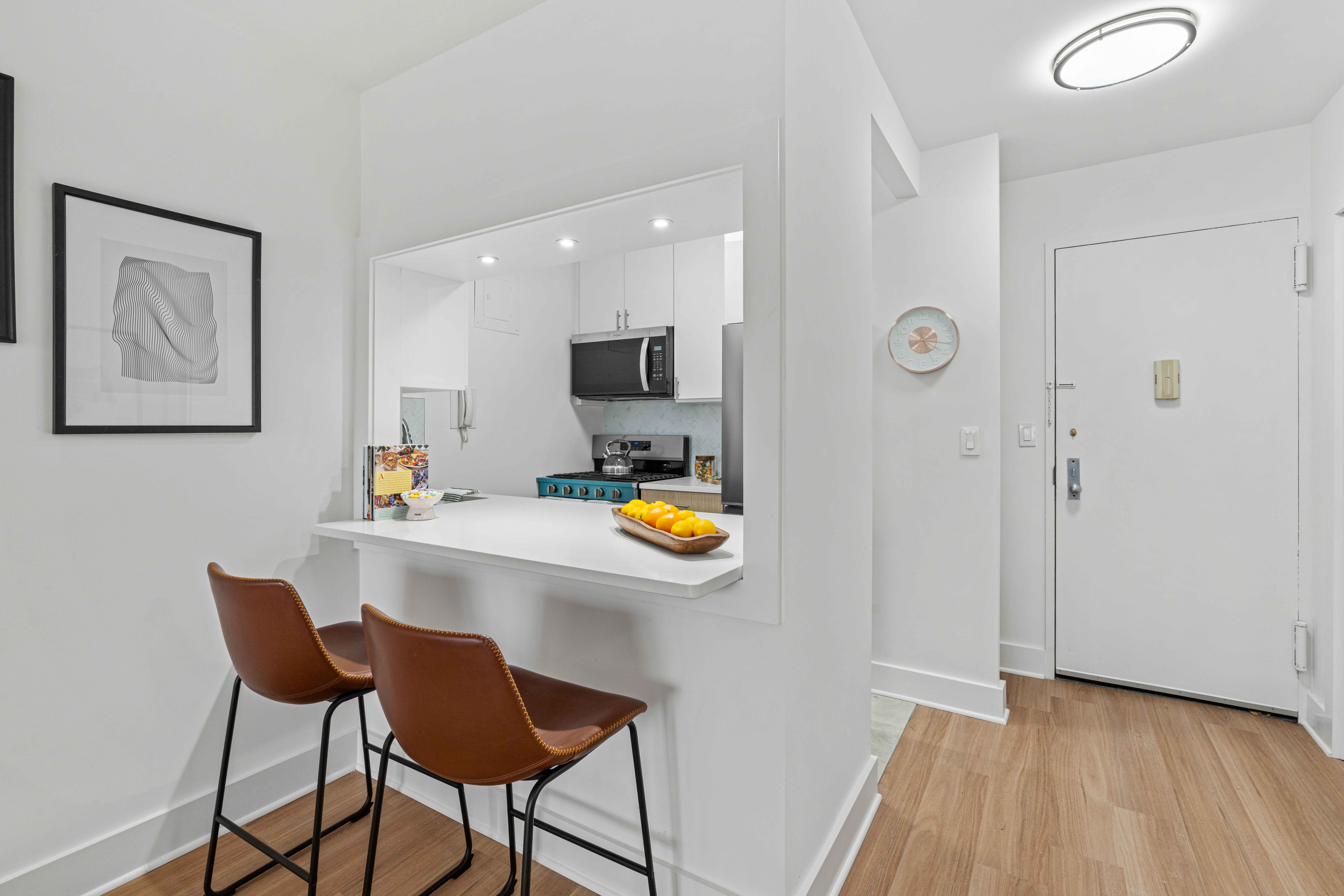 400 East 54th Street, Unit 22D Manhattan, NY 10022 - Photo 4 of 21 a view of dining room with furniture and wooden floor