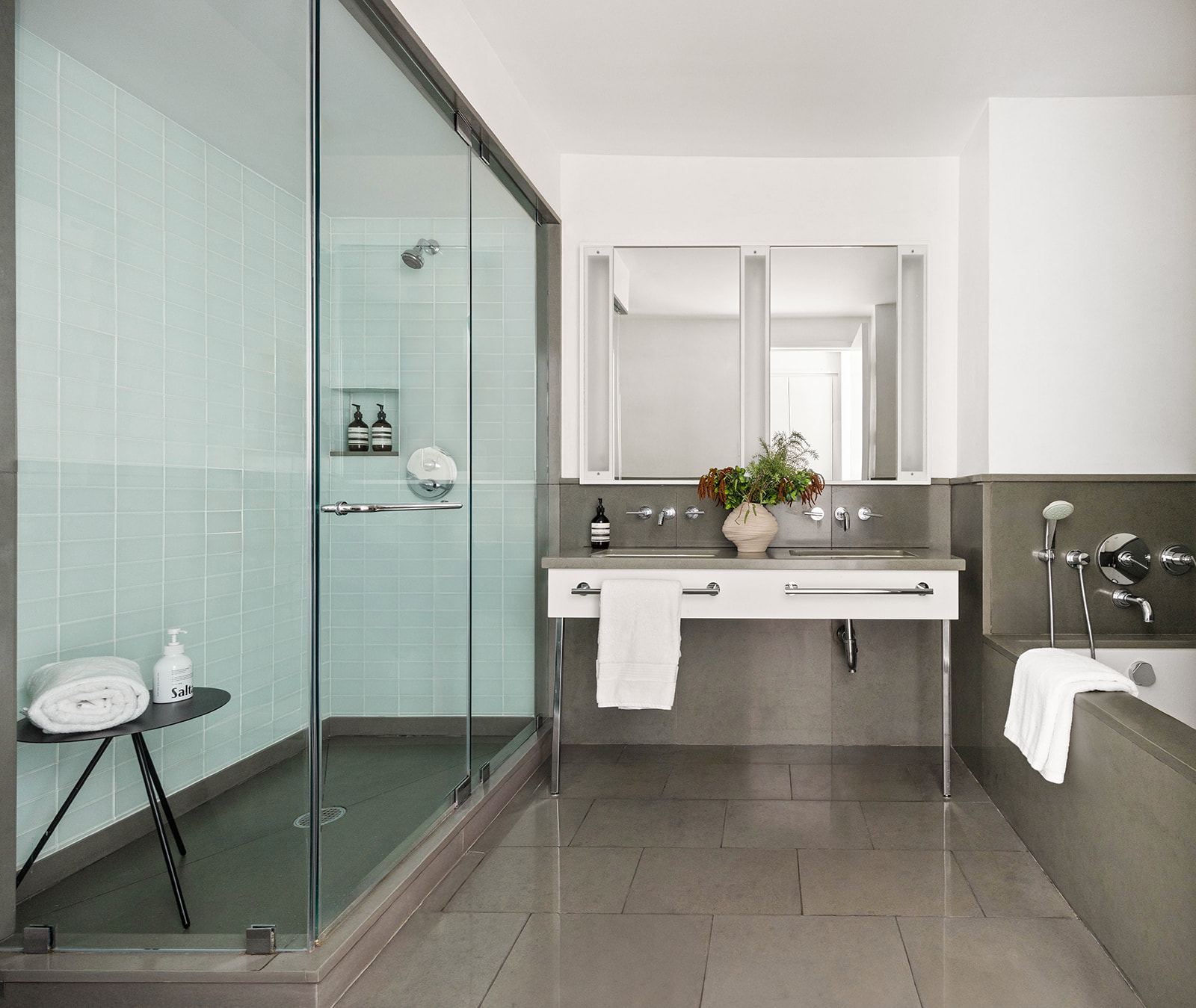 330 Spring Street, Unit 7D Manhattan, NY 10013 - Photo 10 of 11 a bathroom with a double vanity sink mirror and bathtub
