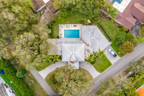 an aerial view of a house with a yard basket ball court and outdoor seating
